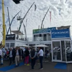 Stand Sogace realizzato con container Showbox al GIS EXPO con area networking e branding