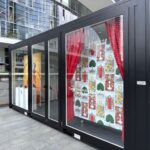 Dettaglio delle vetrate e dell’allestimento grafico del pop-up Alfaparf Milano Professional in container.