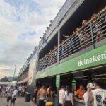 Dettaglio della VIP Lounge con terrazze panoramiche, parapetti metallici e punti bar brandizzati Heineken.
